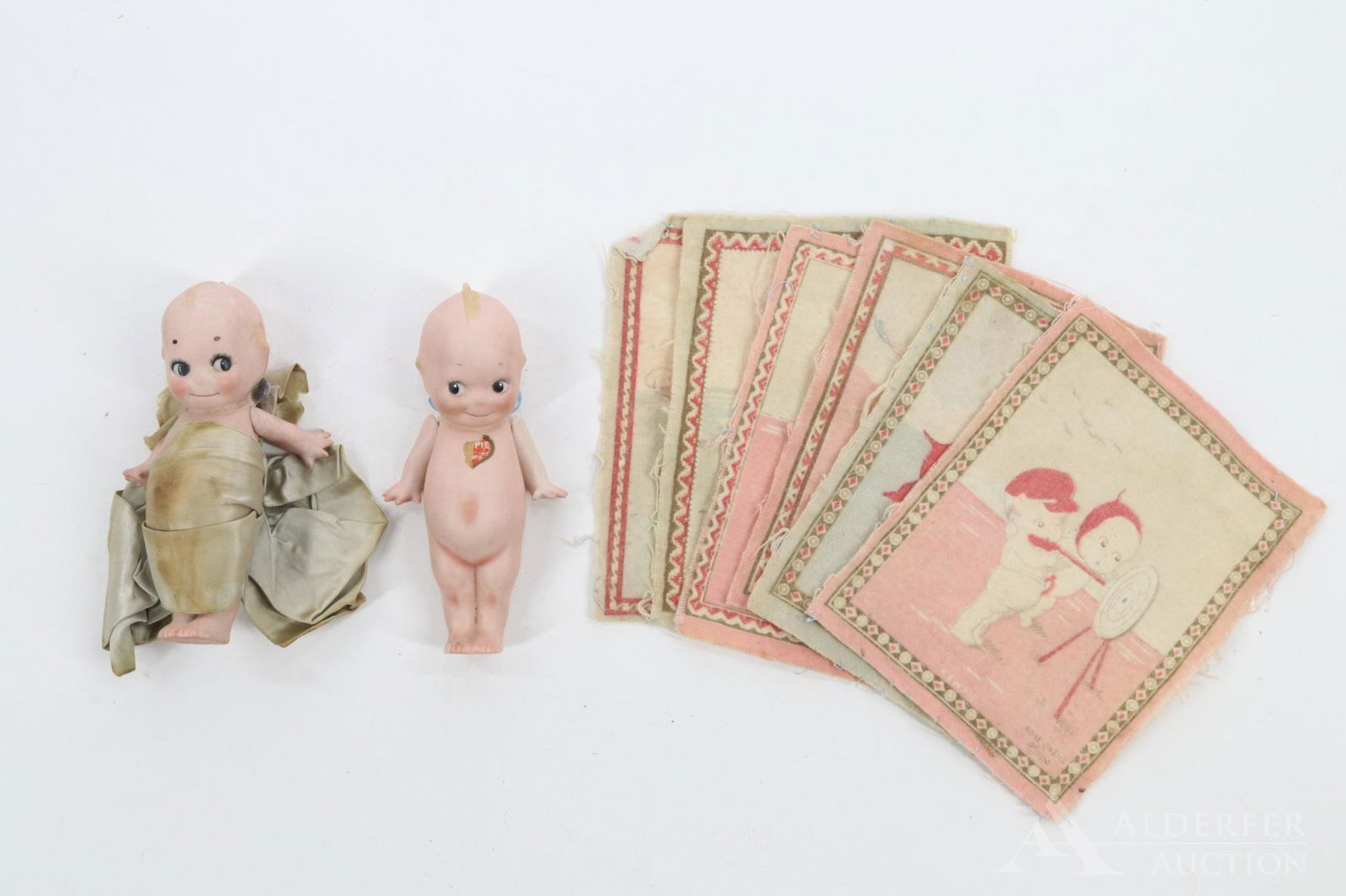 LOT OF ALL BISQUE DOLLS.: Pair of 5" standing Kewpie dolls. Doll 1) has eyes glancing to the right. Paper label on front and back, No clothing. Pencilled on back: Mother Garlock Sr. 1911 Robert Garlock Birth. Condition: arms n