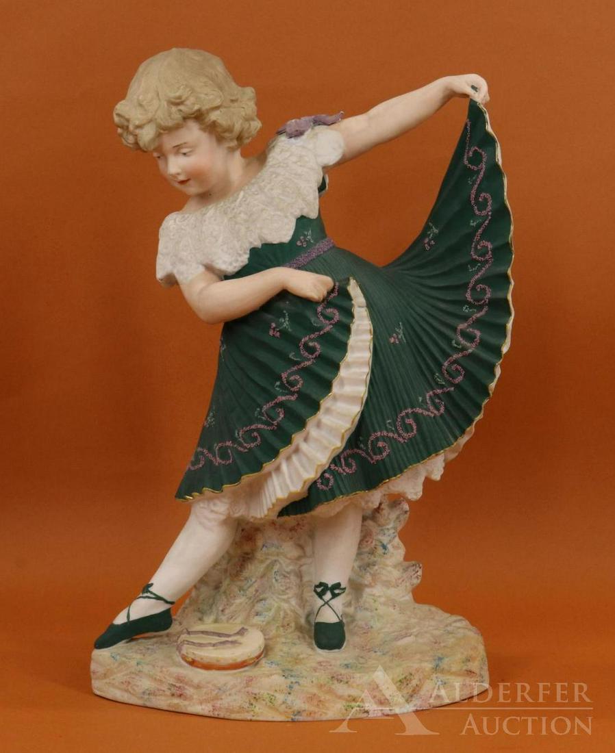 ANTIQUE BISQUE FIGURINE.: 16" HEUBACH Sunburst symbol "Dancing Girl". Blue intaglio eyes. Dressed in fancy dark green pleated dress with pink "embroidery" detail. Condition: nothing observed.