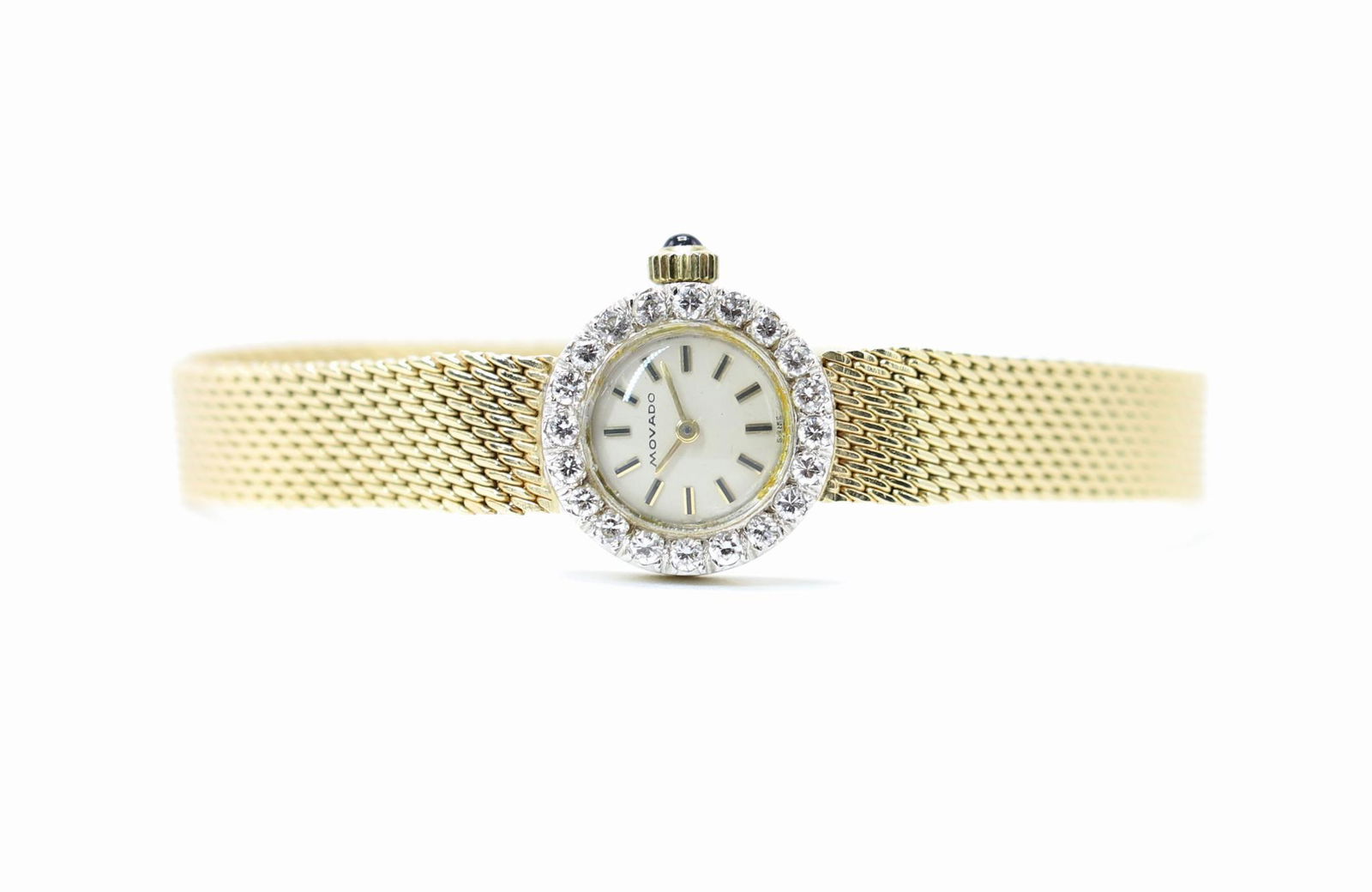 Movado 14KY Gold Diamond Ladies Wrist Watch: Bezel features (20) round diamonds, approx. .30ctw. 17 jewel movement. 15.3mm diameter case. 6.75" long with mesh bracelet. Currently running but not tested or guaranteed. 18.0gtw