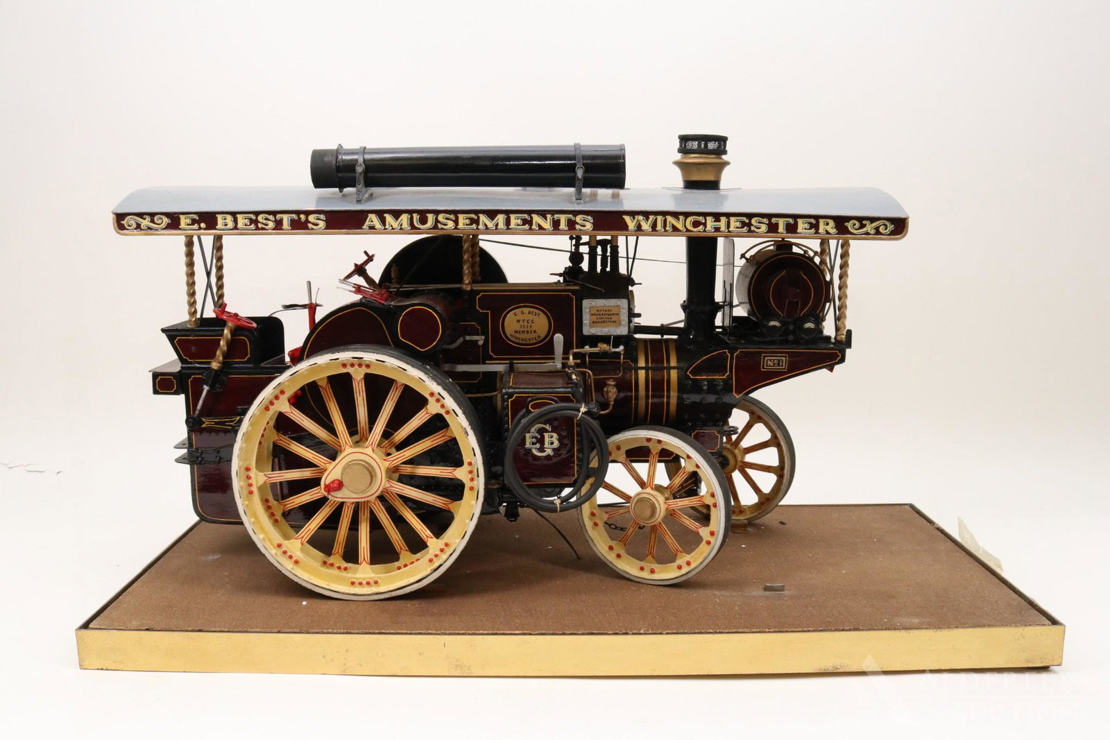 Wallis and Steevens Steam Tractor Model: Hand decoratedc wooden model of a Willis & Steevens steam powered tractor. Decorated in maroon and gold "E. Best's Amusements Winchester". 11.75"h x 18.75"w x 9"d