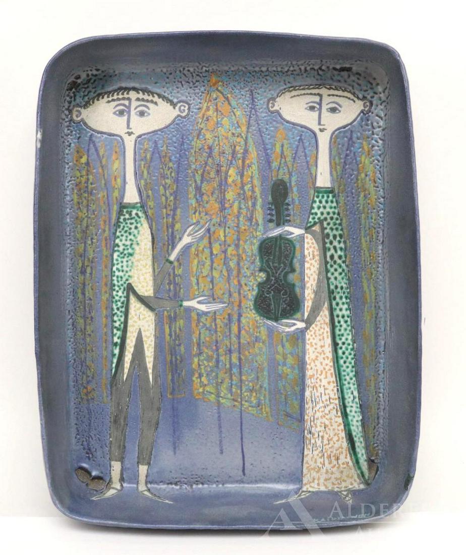 Birger Kaipiainen (Finland, 1915-1988): Ceramic art platter designed by Birger Kaipiainen for Arabia with a man and woman exchanging a violin. 18"h x 14"w x 4.5"w