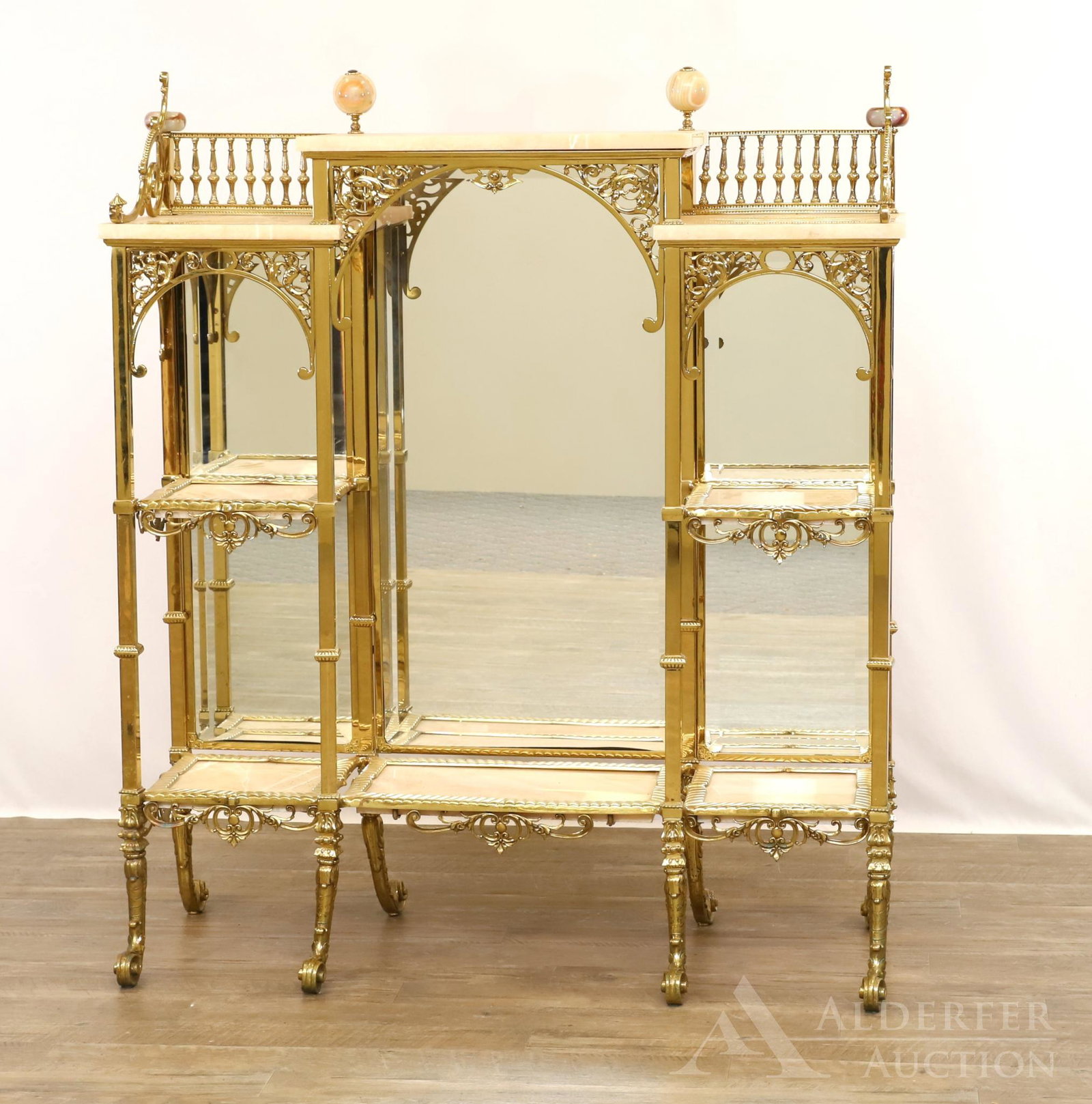 Brass and Marble Etagere: Ornate brass frame with gallery top and three tier marble shelving on scrolled feet. 48"h x 45"w x 12"d