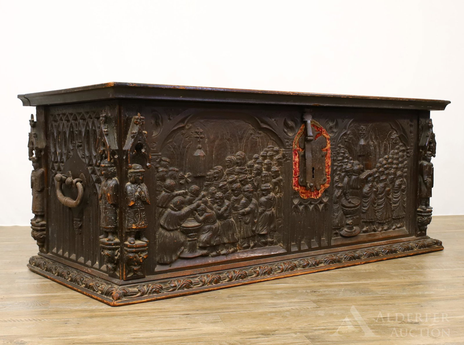 19th c. Continental Relief Carved Blanket Chest: Mahogany with figural carved panels and columns, iron fixtures on a repeating carved foliate plinth. 23"h x 58"w x 26"d