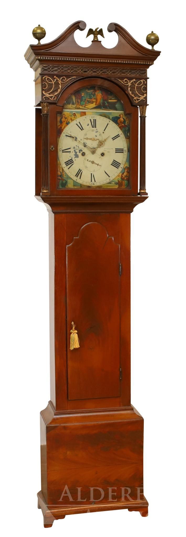 McGregor St. Ninian's Scottish Tall Case Clock: 19th c. Mahogany case with the bonnet having a broken arch pediment with a brass center eagle finial, dentil molded cornice, fretwork, and fluted columns. Shaped waist door with a molded plinth on sha