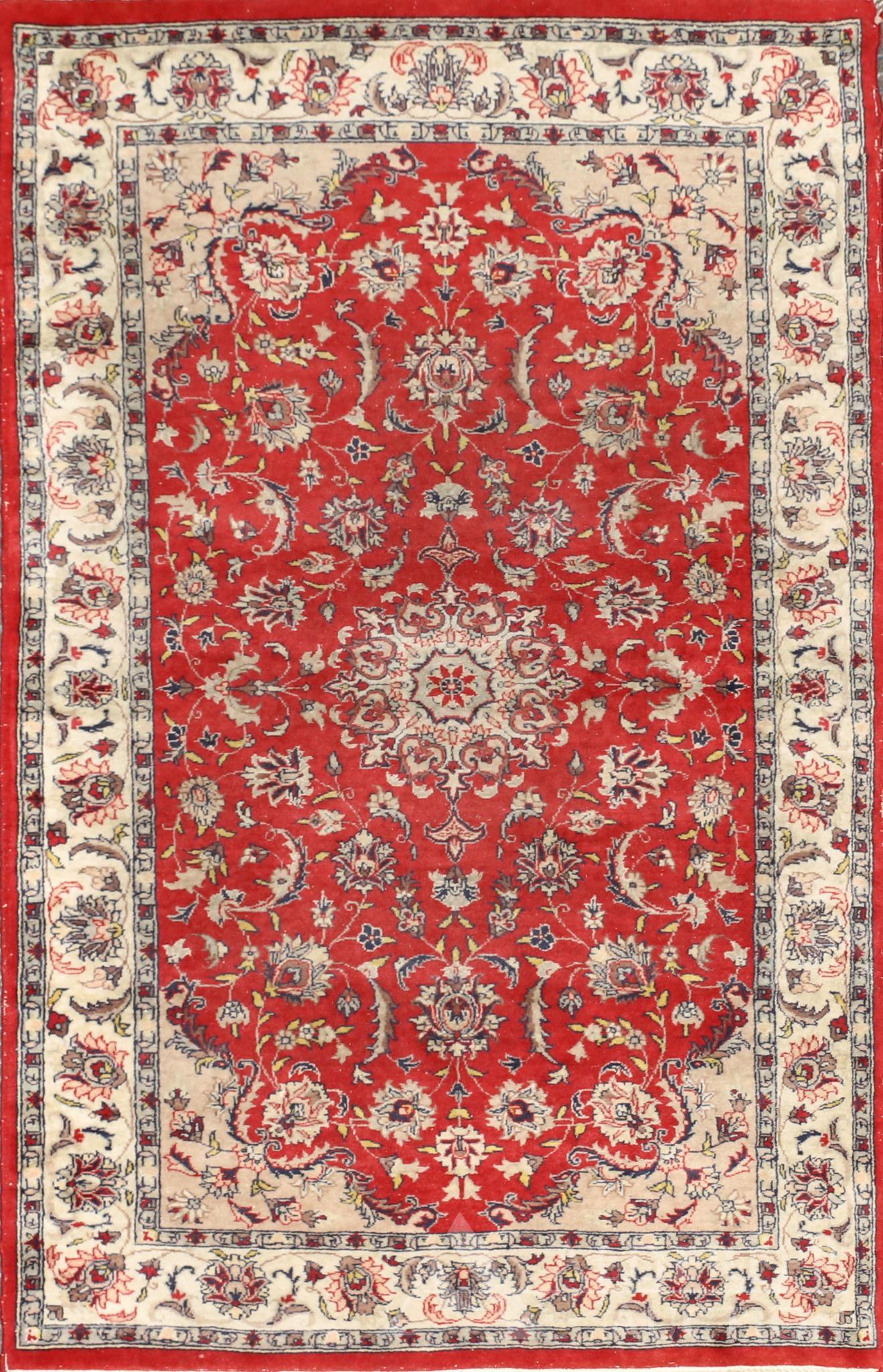 Persian Tabriz Area Rug: Floral medallion with floral and sprig design in a red field with ivory spandrels and borders. Hand woven. 5'4"l x 3'2"w