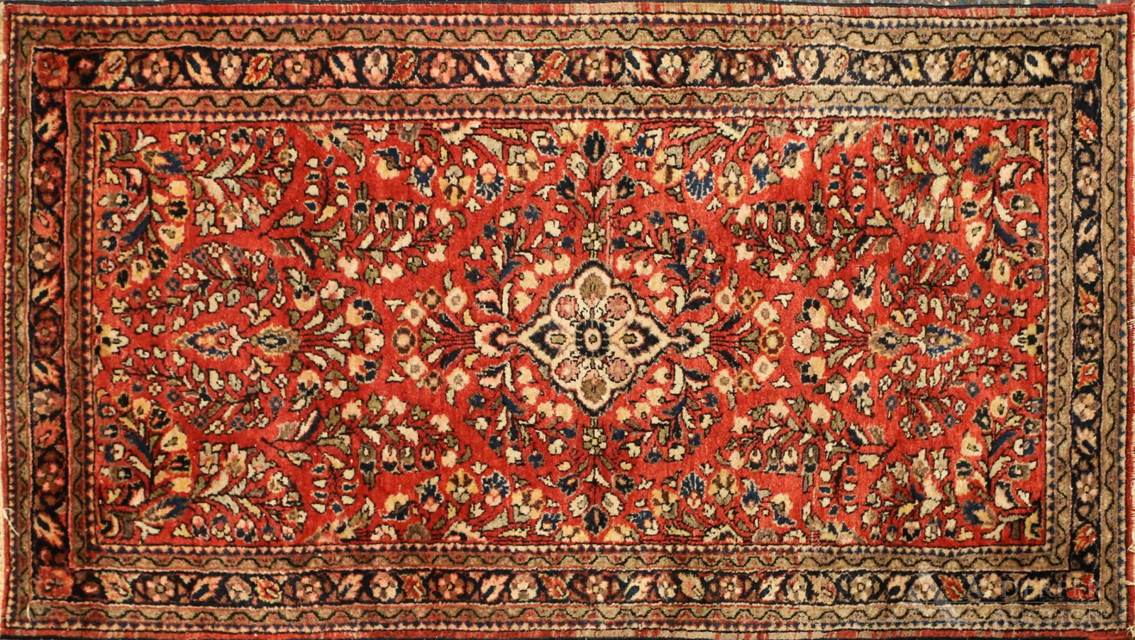Persian Sarouk Area Rug: Ivory diamond floral medallion with repeating foliate leaf motifs in a red field and navy blue main border. Hand woven. 4'7"l x 2'5"w