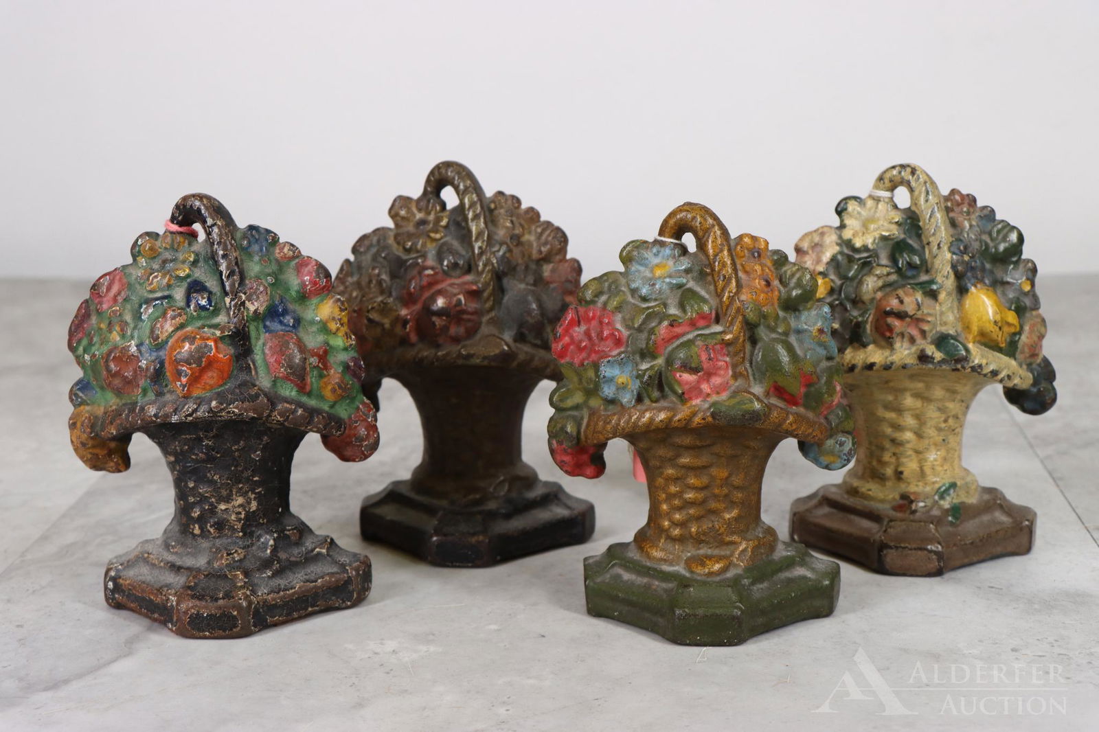Cast Iron Flower Basket Doorstops: Flower baskets, painted cast iron doorstops (4). 5.5"h