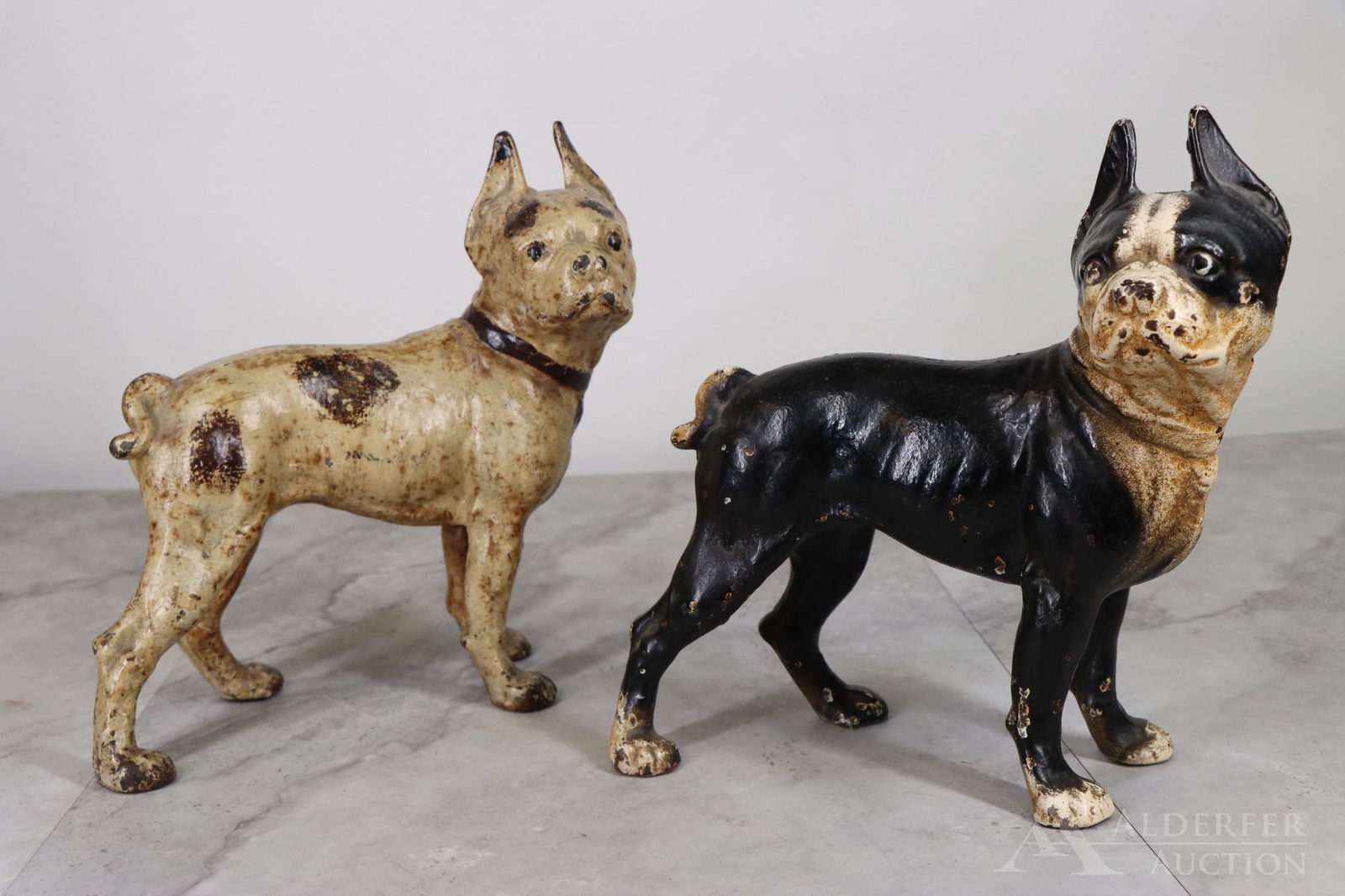 Cast Iron Dog Doorstops: Boston Terriers, painted cast iron doorstops (2), black with white, and white with brown spots and dog collar. 10.5"h
