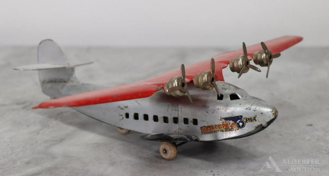 China Clipper Pressed Steel Toy: Painted pressed steel airplane toy, PAA China Clipper. Surface wear. Wingspan 13"