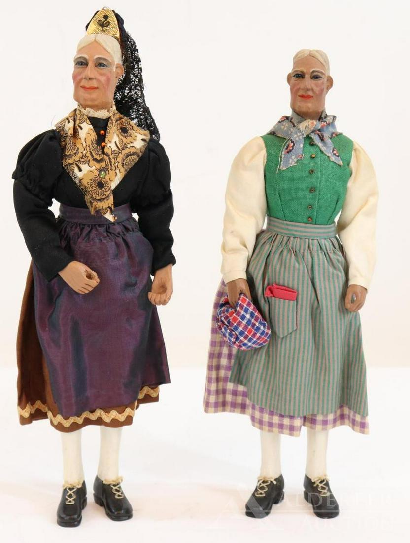 ARTIST DOLL(S).: Pair of wood lady dolls by artist Leopold Gruber. 9 3/4", 10 1/4". Similar to the Swiss Linden wood dolls, but these ladies have stationary blue glass eyes (with molded eyelids). Wood bodies, legs wit