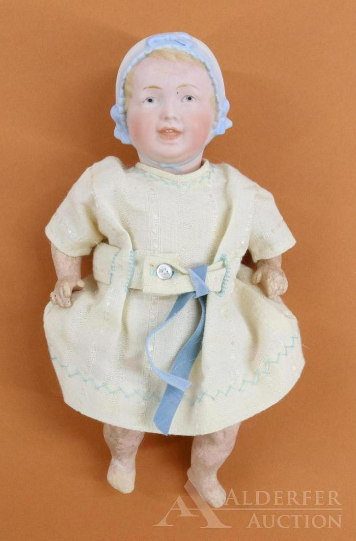 GERMAN BISQUE HEAD DOLLS, 13" AND UNDER.: 9 1/2" 22-7/0 (Recknagel) molded bonnet character baby with blue intaglio eyes, smiling open/closed mouth with (2) teeth. Molded, painted blue/white bonnet. 5 Pc. papier mache bent limb baby body. Dre