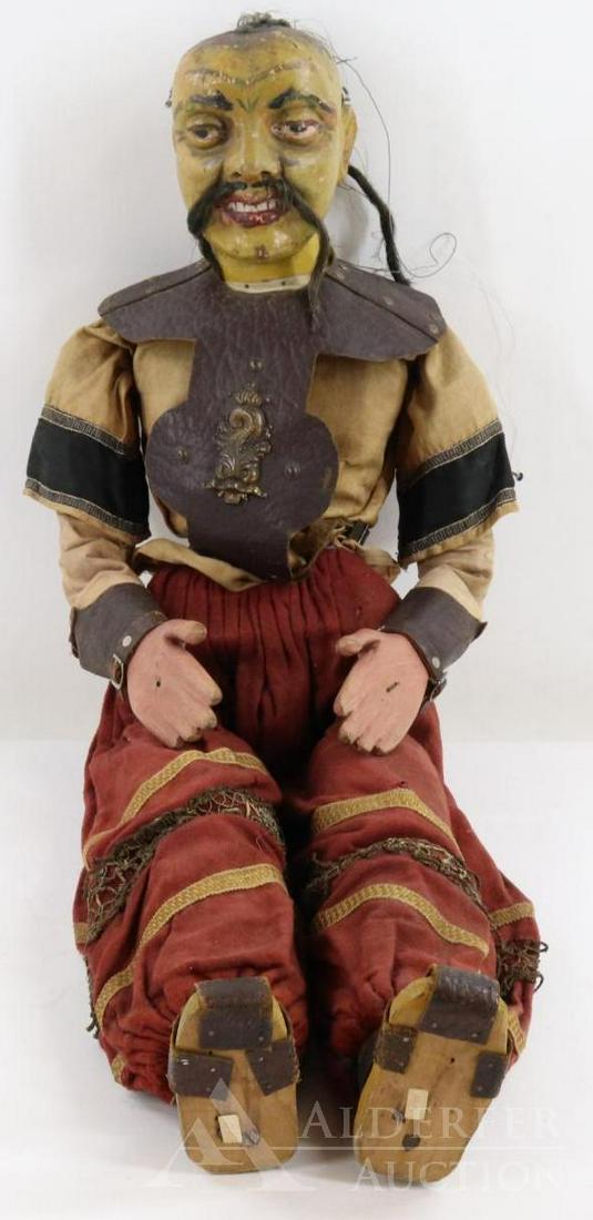 CHARACTER DOLL.: 32" Wooden articulated Mongolian Warrior doll/marionette. Painted features with open/closed mouth and painted teeth. Human hair "queue" and mustache. Clothing of cotton with metallic/lace trims. Studd