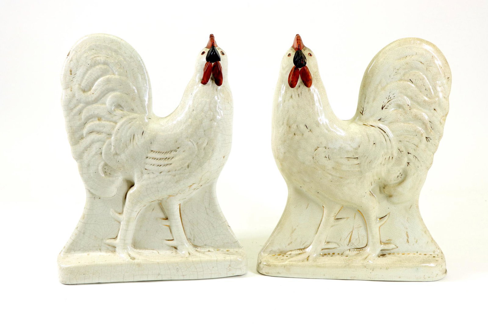 Staffordshire Roosters: English pottery pair of white roosters / cockerels. 12"h x 9.5"w x 4.75"d **Please Note: This item is NOT eligible for in-house shipping. Please refer to the terms and conditions of this auction for r