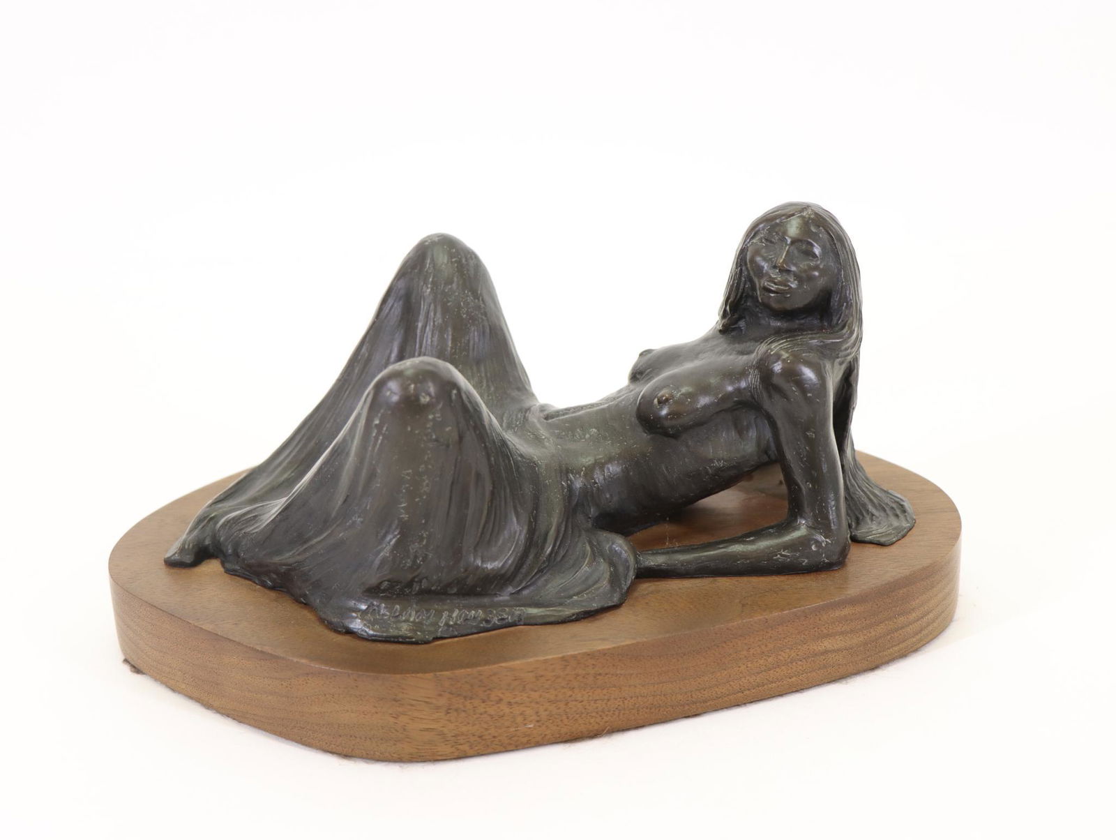 Allan Houser (Apache 1914-1994) Bronze Sculpture: Native American woman, titled "Reclining Nude", signed, dated 1980, numbered 9 of 20, and marked SF. Mounted to a wooden stand. 4"h x 10"w x 7"d