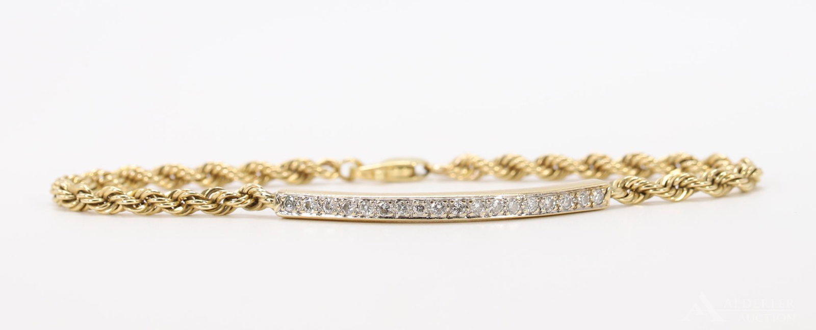 14KY Gold Diamond Bracelet: Rope chain features a curved bar with a channel of pave set round diamonds, approx. .36ctw. 3.2mm wide, 7" long. 7.9gtw