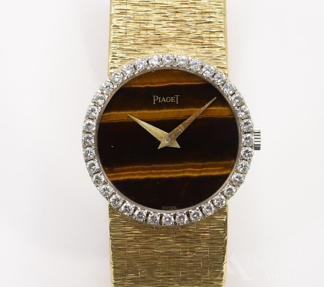 Piaget 18KY Gold Diamond Wrist Watch: Round tiger eye dial features a bezel of round diamonds, approx. .72ctw. Case is marked 9706 A 6 193605. Integrated bracelet has a gentle taper. Case has a 24.0mm diameter, 6" long. 52.1gtw