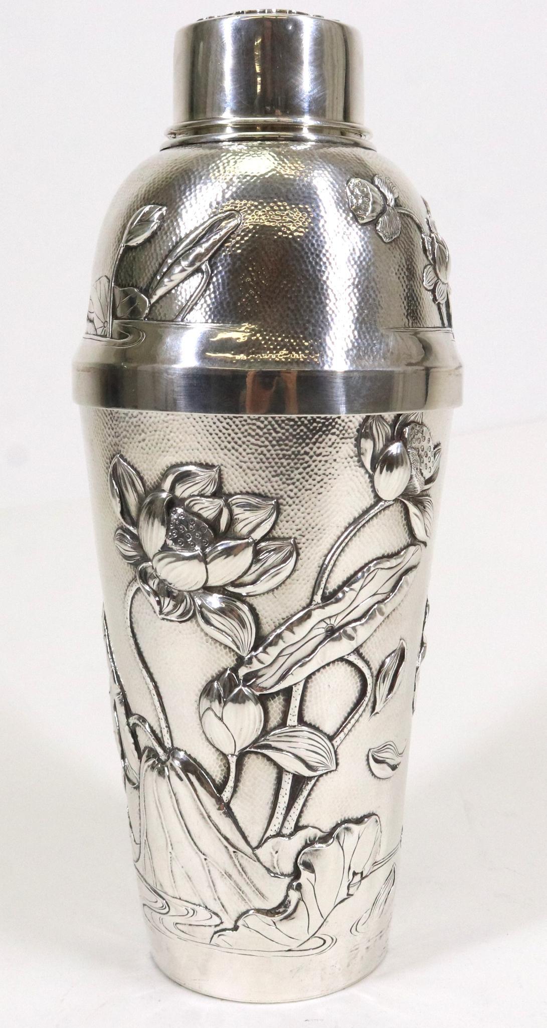 Arthur & Bond Sterling Silver Cocktail Shaker: British/Japanese late 19th or early 20th century shaker with repousse lotus flower decoration over a hammered finish, the strainer covered by a removable top with stylized monogram, set into anot