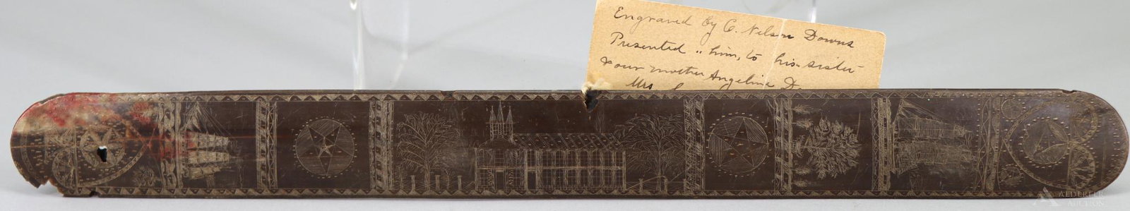 Scrimshaw Baleen Busk-19th Century: Mid-19th century scrimshawed baleen busk measuring 13.75" x 1.25" with one side featuring scrimshawed central portion of a church and trees. This central image is flanked on both sides by an image of 