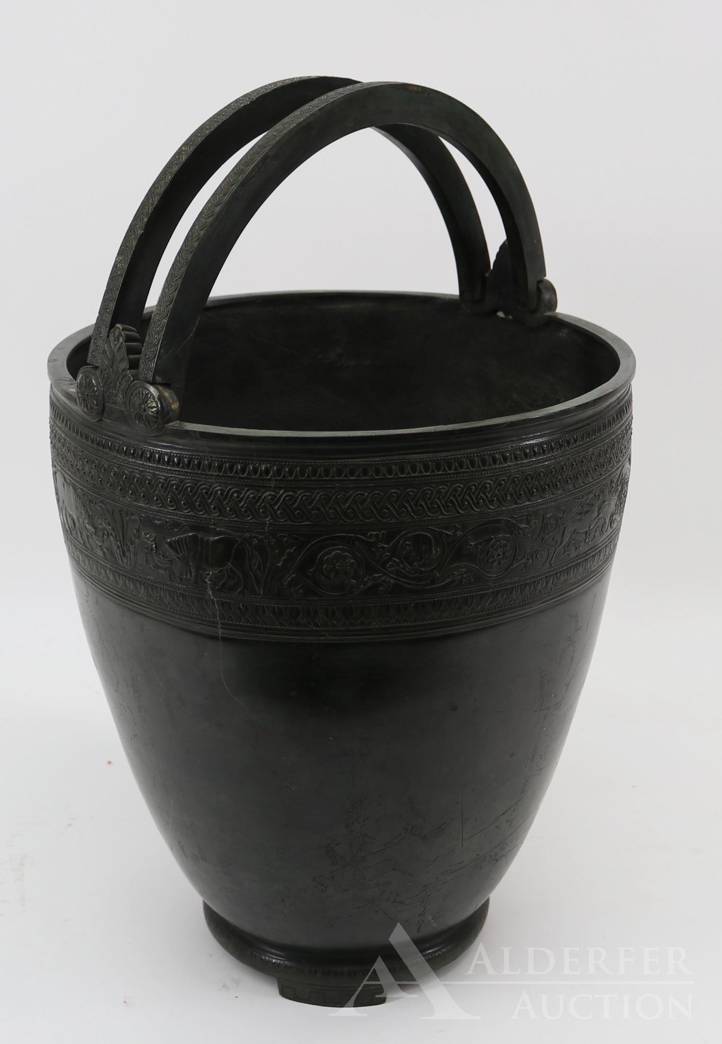 Grand Tour Bronze Situla: After the antique, Etruscan style footed patinated bronze situla with double bail handles, rosettes, and frieze depicting animals, foliage, and geometric motifs, 19th century. 14.5"h x 12.5"w **Please