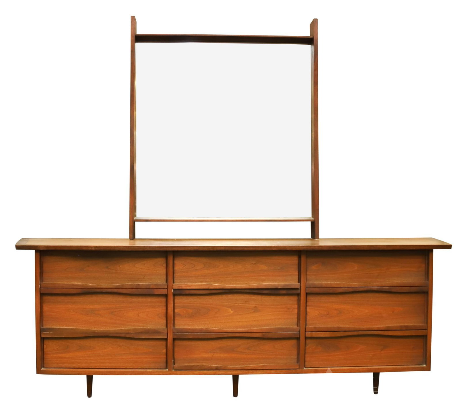 George Nakashima for Widdicomb Dresser and Mirror: Walnut, peg construction, trapezoidal top, three triple sided drawers, with lipped handles, on tapered legs. Loss to one back corner. 32"h x 98"w x 22"d **Please Note: This item is NOT eligible for in