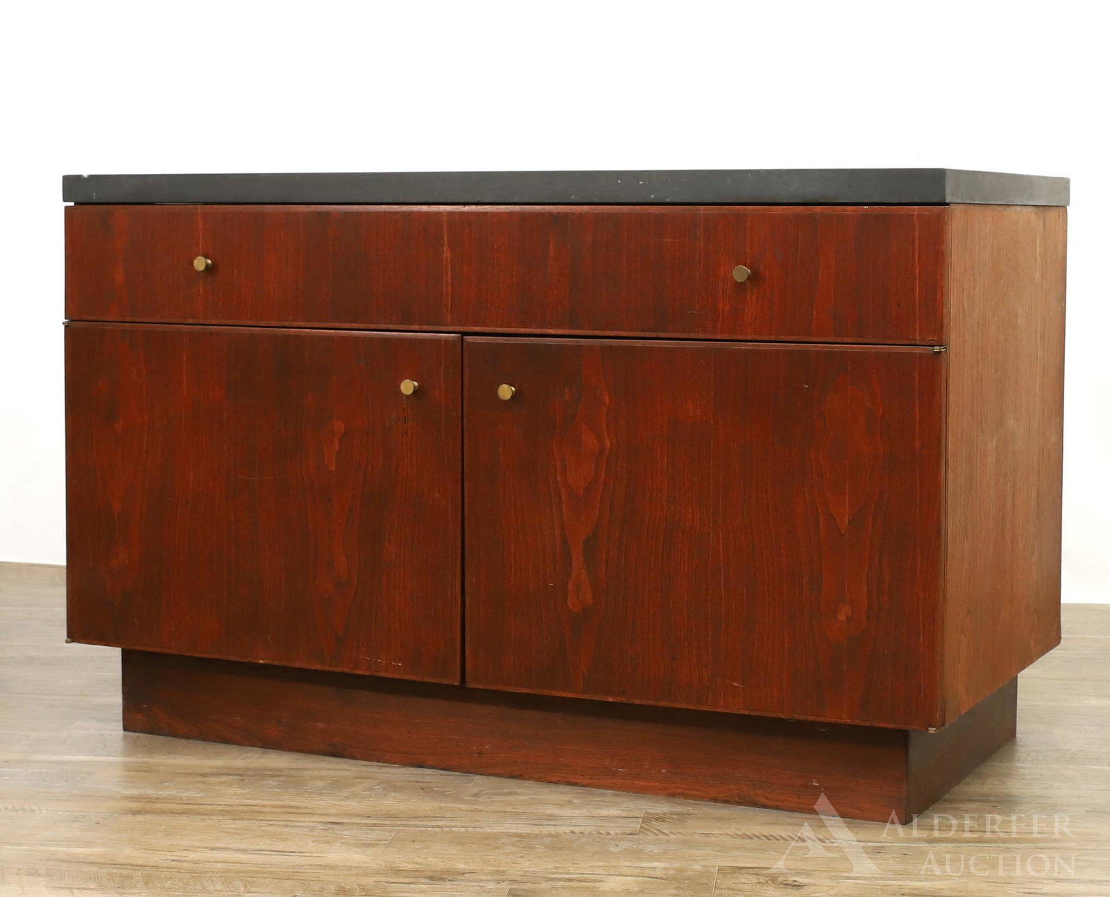 Modernist Walnut Slate Top Bar Cabinet: One drawer over two doors on a square base. 29.5"h x 27"w x 23"d **Please Note: This item is NOT eligible for in-house shipping. Please refer to the terms and conditions of this auction for recommende