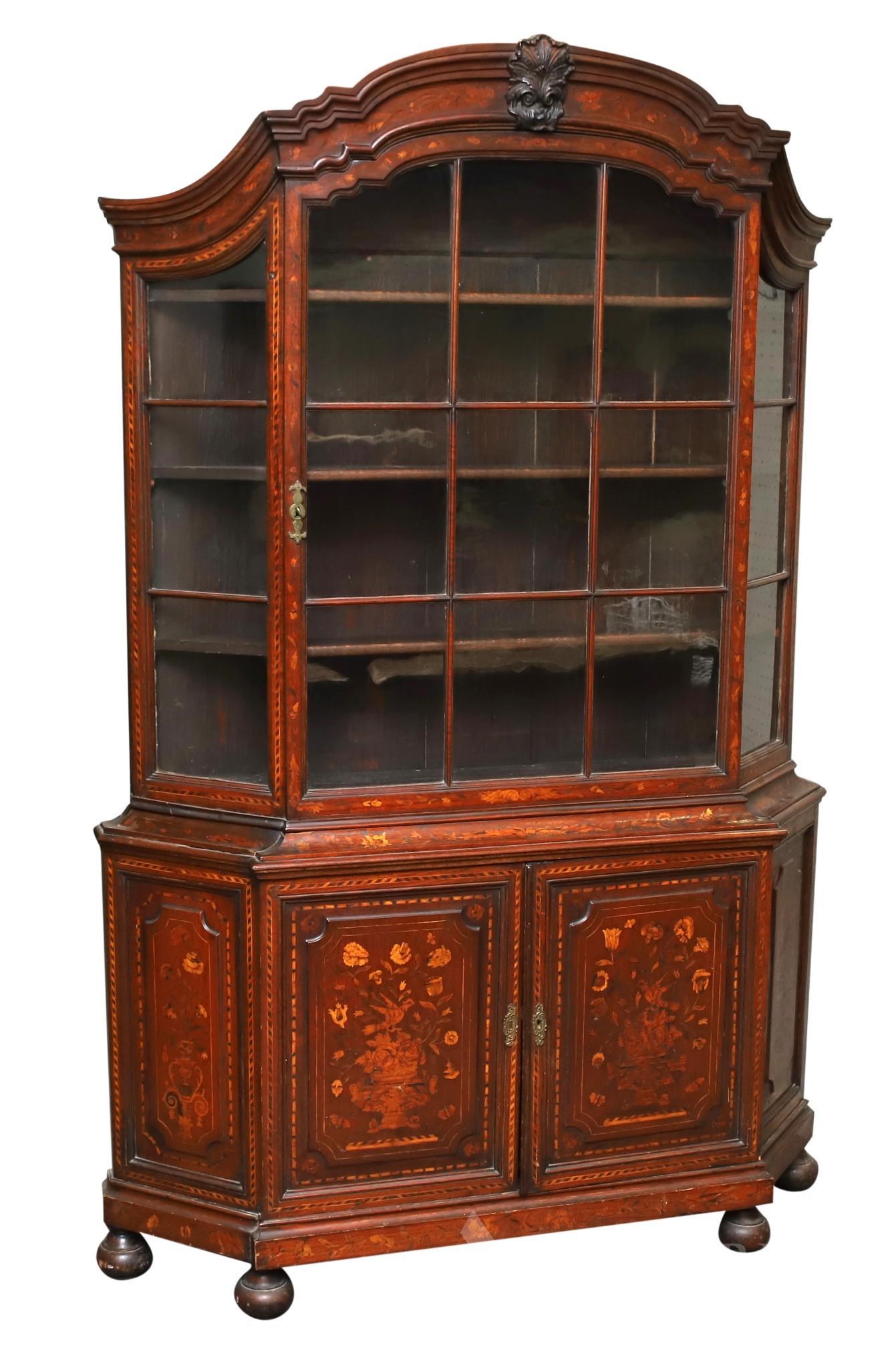 Dutch Marquetry and Inlaid Walnut Cupboard: Two-piece. Curved and wavy molded cornice with center acanthus, fifteen light glazed door with banded inlay and bell flower motifs over two doors flanked by two side panels all with urn, aviary, and f