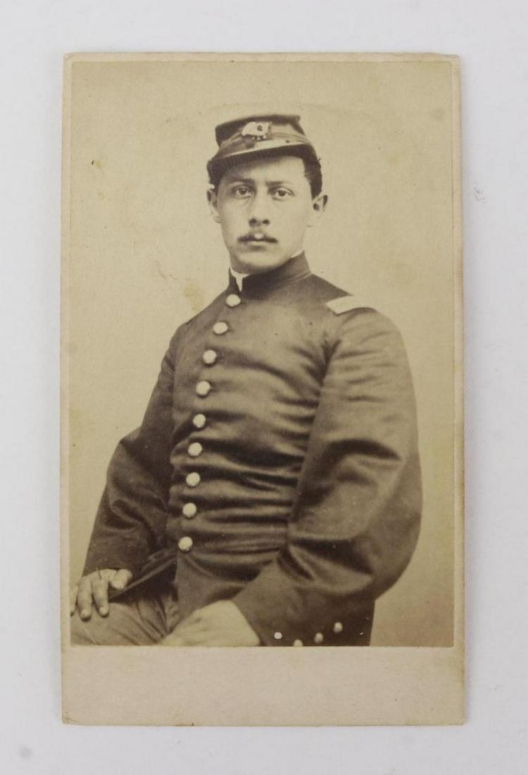 CDV of Lieutenant Ezekiel Gaulbert Tomlinson-54th: Carte de visite photograph of a waist up seated view of Ezekiel Gaulbert Tomlinson wearing uniform with lieutenant's shoulder straps and kepi. Carte presents pencil inscription on reverse "E. G. Tomli
