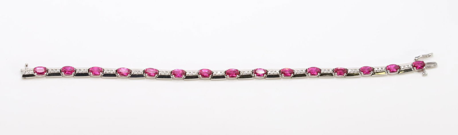 14KW Gold Rubellite and Diamond Bracelet: Oval pink tourmaline links alternate with polished pyramidal brick links set with trios of small round diamonds, approx. .675ctw. 4.6mm wide, 7.25" long. 11.7gtw