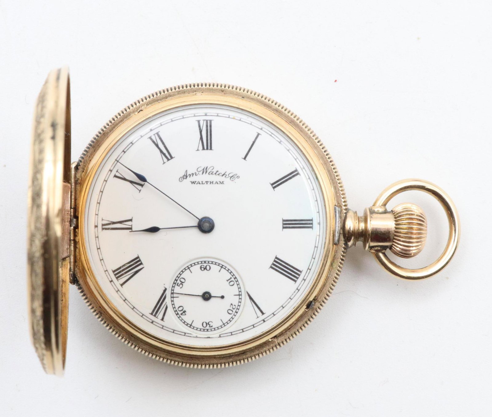 14K Rose Gold Am Watch Co Pocket Watch: Engine turned and engraved hunter case with monogrammed front cover. White single sunk dial with black Roman numerals, and blue spade hands. Side stem wind, lever set. Polished cuvette. Currently runn