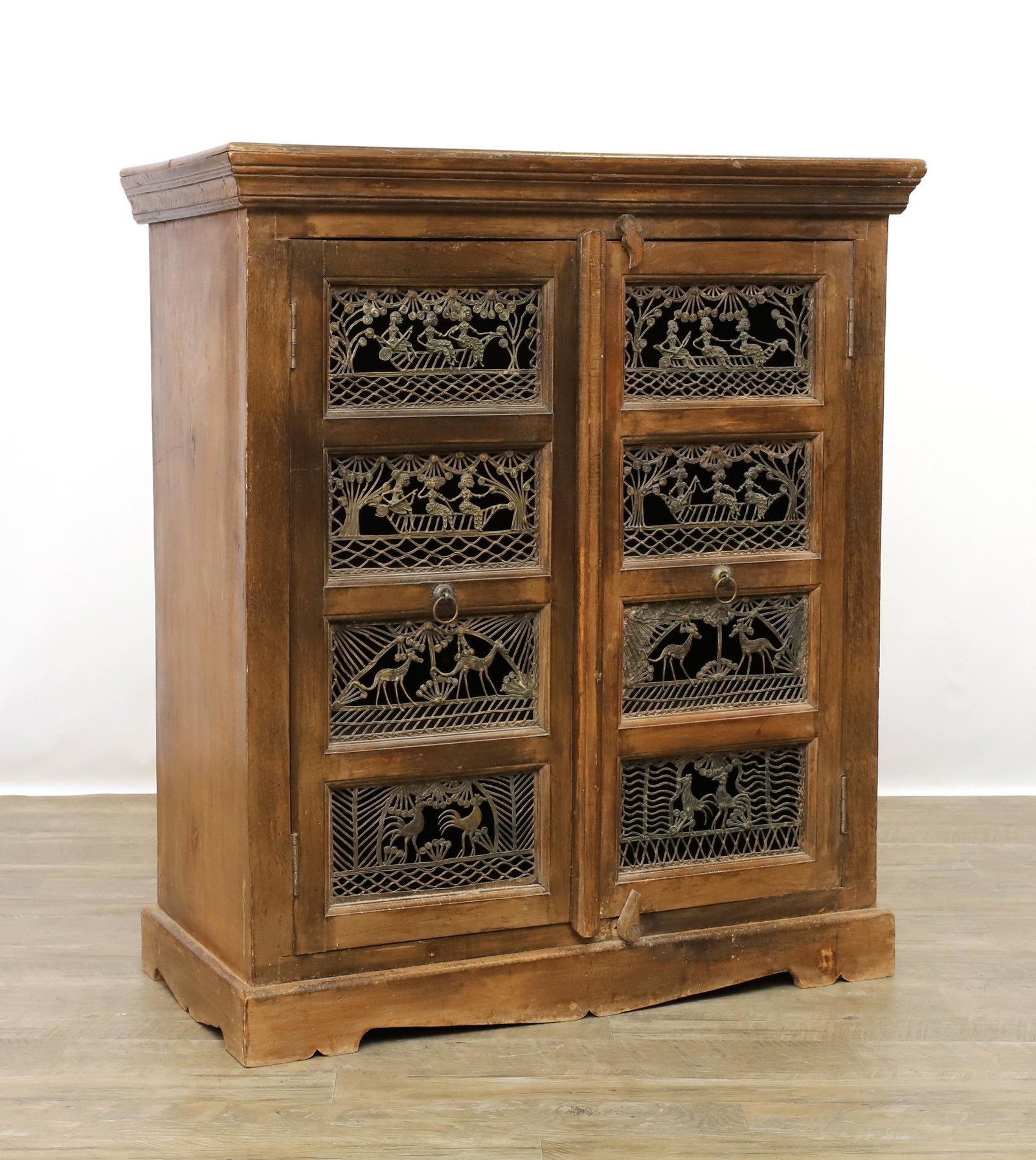 African Motif and Afromosia Console Cabinet: Molded cornice, two lattice African motif doors on shaped feet. 41"h x 35"w x 17"d **Please Note: This item is NOT eligible for in-house shipping. Please refer to the terms and conditions of this auct
