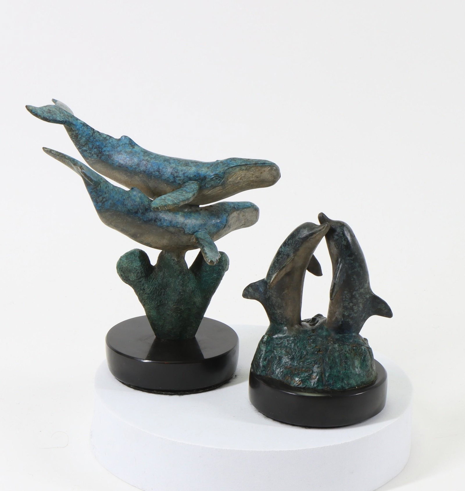 Robert Wyland (American b. 1956): Humpback whale grouping, signed, dated 1992, and numbered 103 of 950. 6"h x 4"w x 5.5"d. Dolphin grouping, signed, dated dated 1992, and numbered 99 of 950. 4"h x 3.5"w x 2.75"d **Please Note: This it