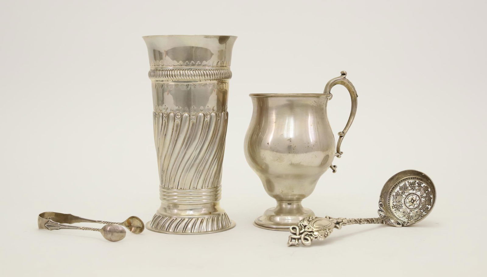 Victorian British Sterling Silver Tablewares: Barnard & Sons, London 1873 sugar sifter with ornate floral and grapevine motif. 5.5". L. Spiers, Birmingham 1891 sugar tongs with twist handle. 3.5". Charles Stuart Harris, London 1892 vase with repo