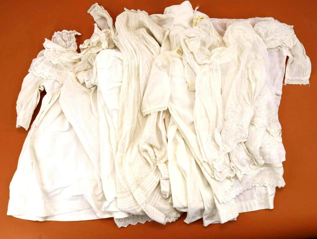 LOT OF ANTIQUE/VINTAGE CLOTHING.: Lot of antique white cotton clothing. Baby - (4) long gowns. Condition: blue stains on (1) gown. Children's - (4) dresses inc. pique with eyelet collar and neck ruffle. This lot is being sold AS IS.