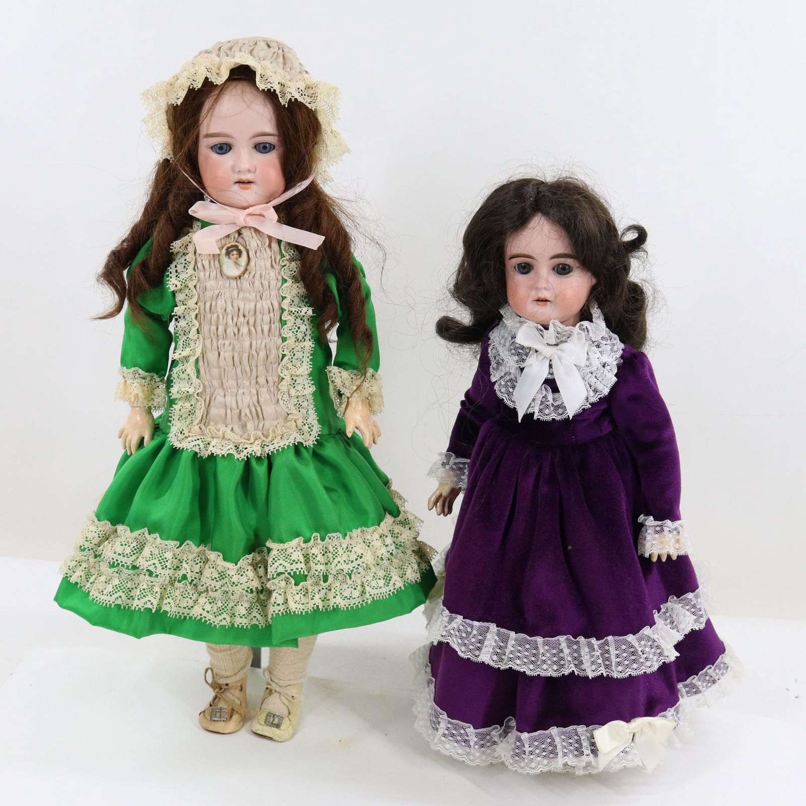 GERMAN BISQUE HEAD DOLL(S).: Pair of dolls with blue sleep eyes, open mouths, brown wigs, papier mache jointed bodies. They are both dressed in newer clothing. 16" A.W. & CO. (in diamond symbol) MADE IN GERMANY A.M. 2 Doll with s