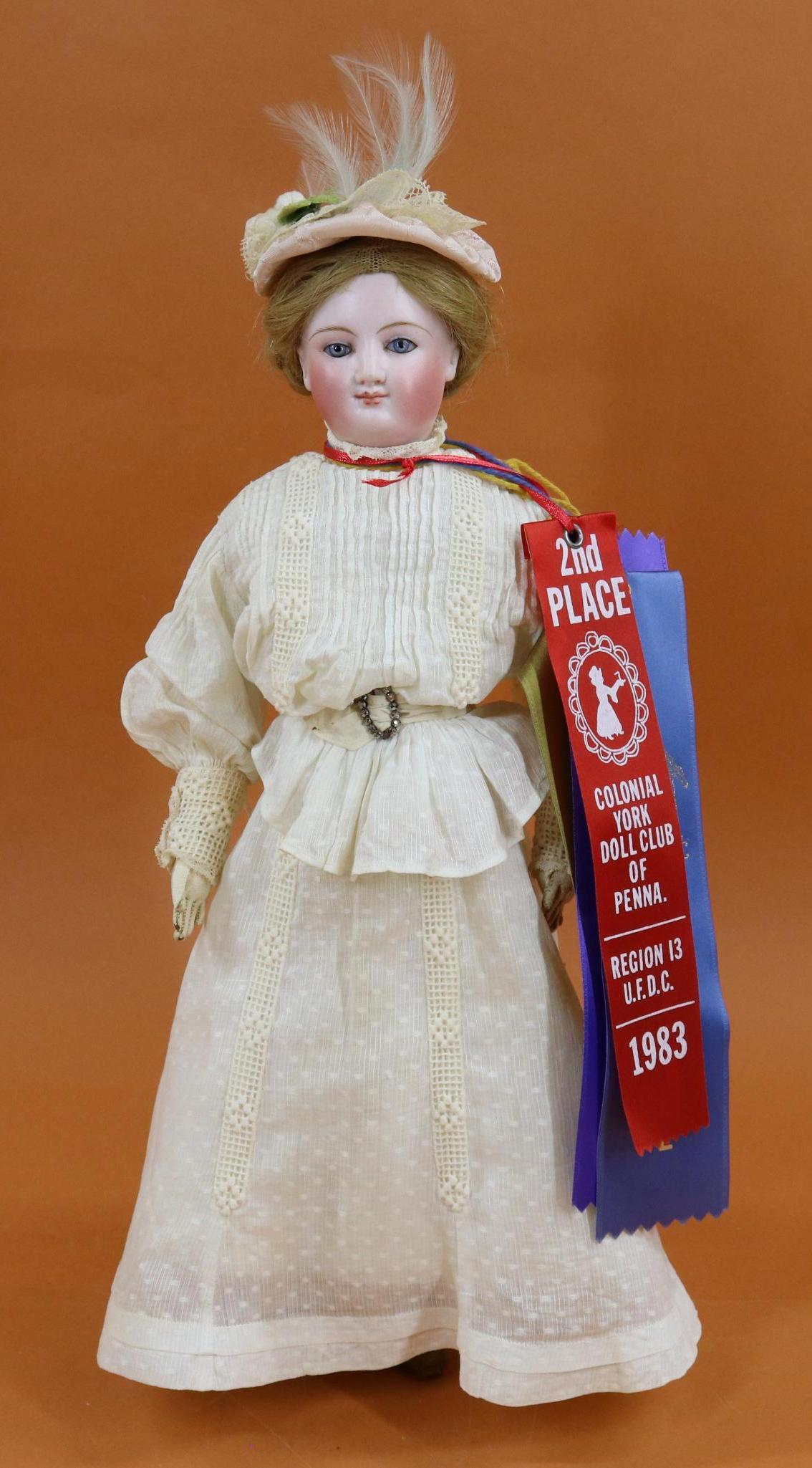 FRENCH BISQUE HEAD FASHION/TYPE DOLL.: 14" "D" (On rim edge) Swivel neck doll with blue paperweight eyes, closed mouth, pierced ears, blonde double coil braided human hair wig, cork pate. Bisque shoulder plate. Leather gusseted body; arms 