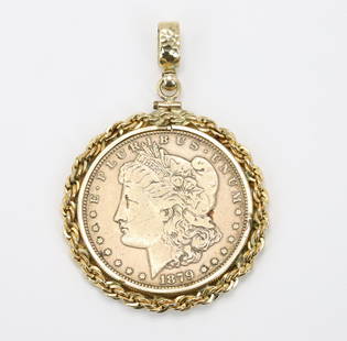 Morgan Dollar Coin Pendant in 14K?Y Gold: Pendant features an 1879 United States of America one dollar Liberty head coin in a 14k(?)y gold rope bezel with a hammered gold bail. 35.4gtw