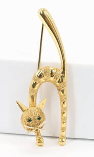 18KY Gold Cat Pin: Pin in 18ky gold features a striped cat with arched back, raised tail, and faceted green eyes peering out from a diamond textured face with polished ears and whiskers, 2" tall with a locking c-clasp.