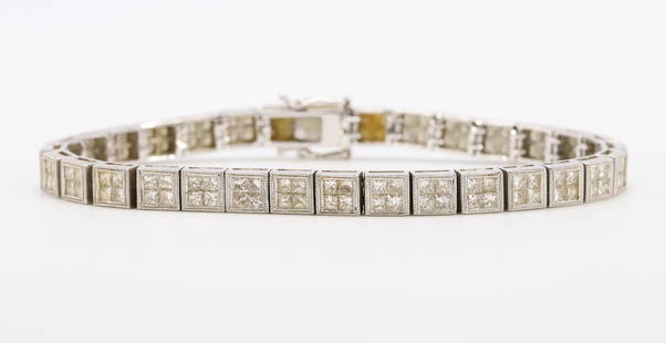 18KW Gold Diamond Bracelet: Tennis style with (4) invisible set princess cut diamonds in each link, approx. 7.68ctw. 5.2mm wide, 7" long with a double safety catch. 20.6gtw