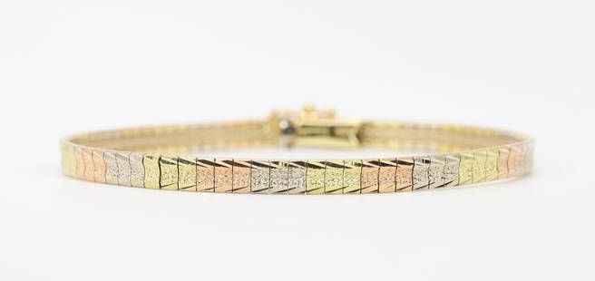 14K Tri-Colour Gold Bracelet: Bracelet in 14k tri-colour gold features polished yellow gold foxtail edging with diamond textured tile links in rose, yellow and white gold. 4.0mm wide. 9.2gtw