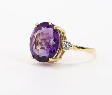 14KY Gold Amethyst and Diamond Ring: Ring in 14ky gold features an oval amethyst flanked by round diamonds, approx. .22ctw. 14mm wide, size 7.75. 4.2gtw