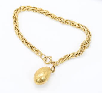 18KY Gold Bracelet with Charm: Bracelet in 18ky gold features a decorative egg charm engraved "Auguri", on fancy wheat link chain, 7.5" long. 8.9gtw