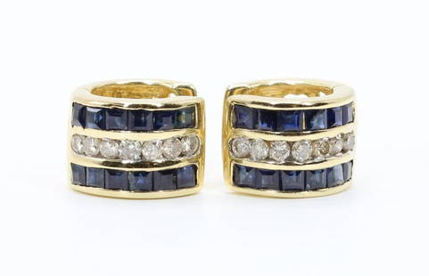 14KY Gold Sapphire and Diamond Earrings: Sapphire and diamond huggie hoop earrings in 14ky gold feature channels of dark blue princess cut sapphires flanking series' of round diamonds, pair approx. .21ctw diamond. Back gold segments are cut