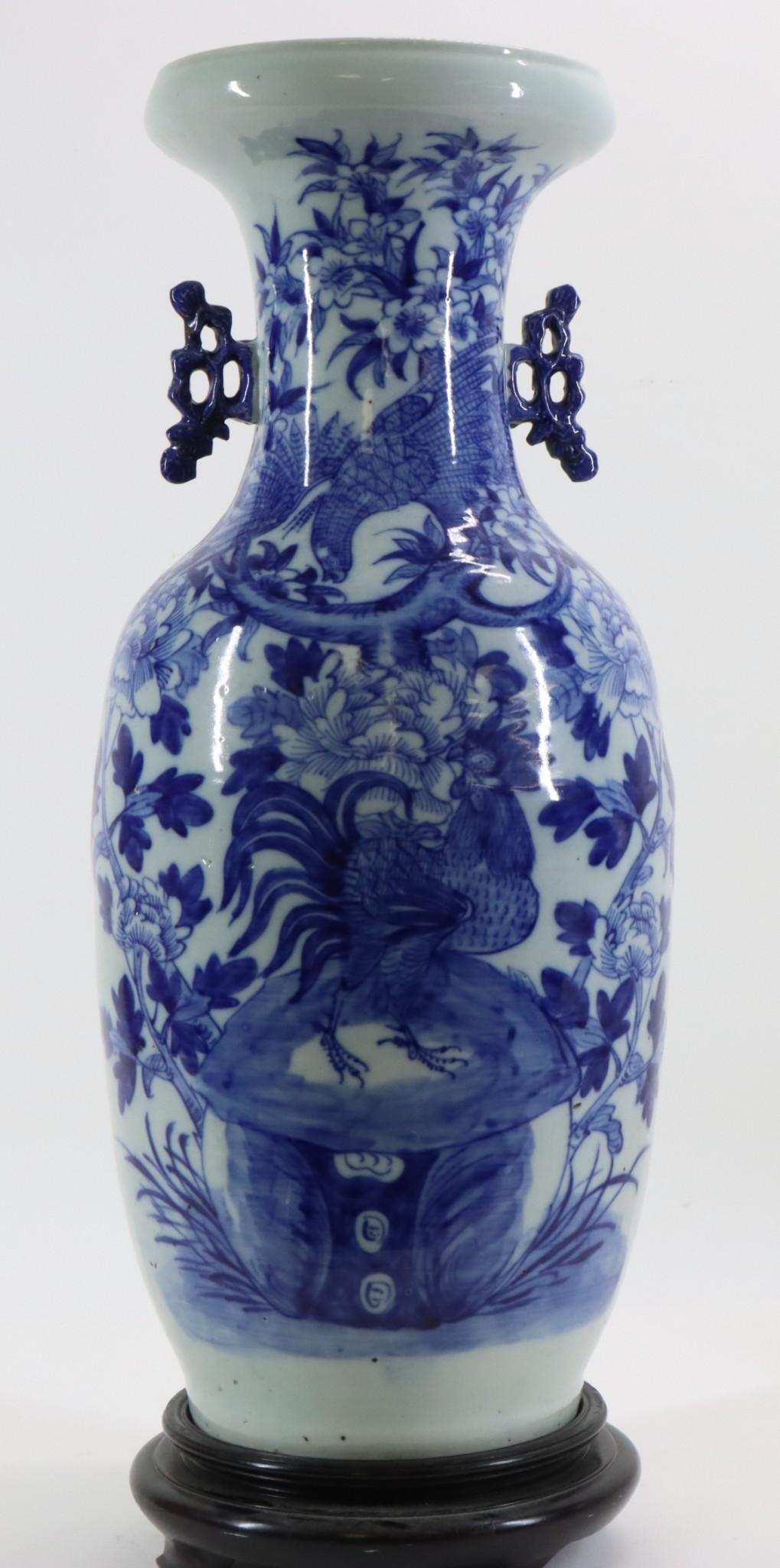 Chinese Blue & White Vase: Floor vase decorated with a hawk and rooster in a garden, stylized dragon handles, 19th century. Hairlines to the foot. 23"h x 8.5"w **Please Note: This item is NOT eligible for in-house shipping. Ple