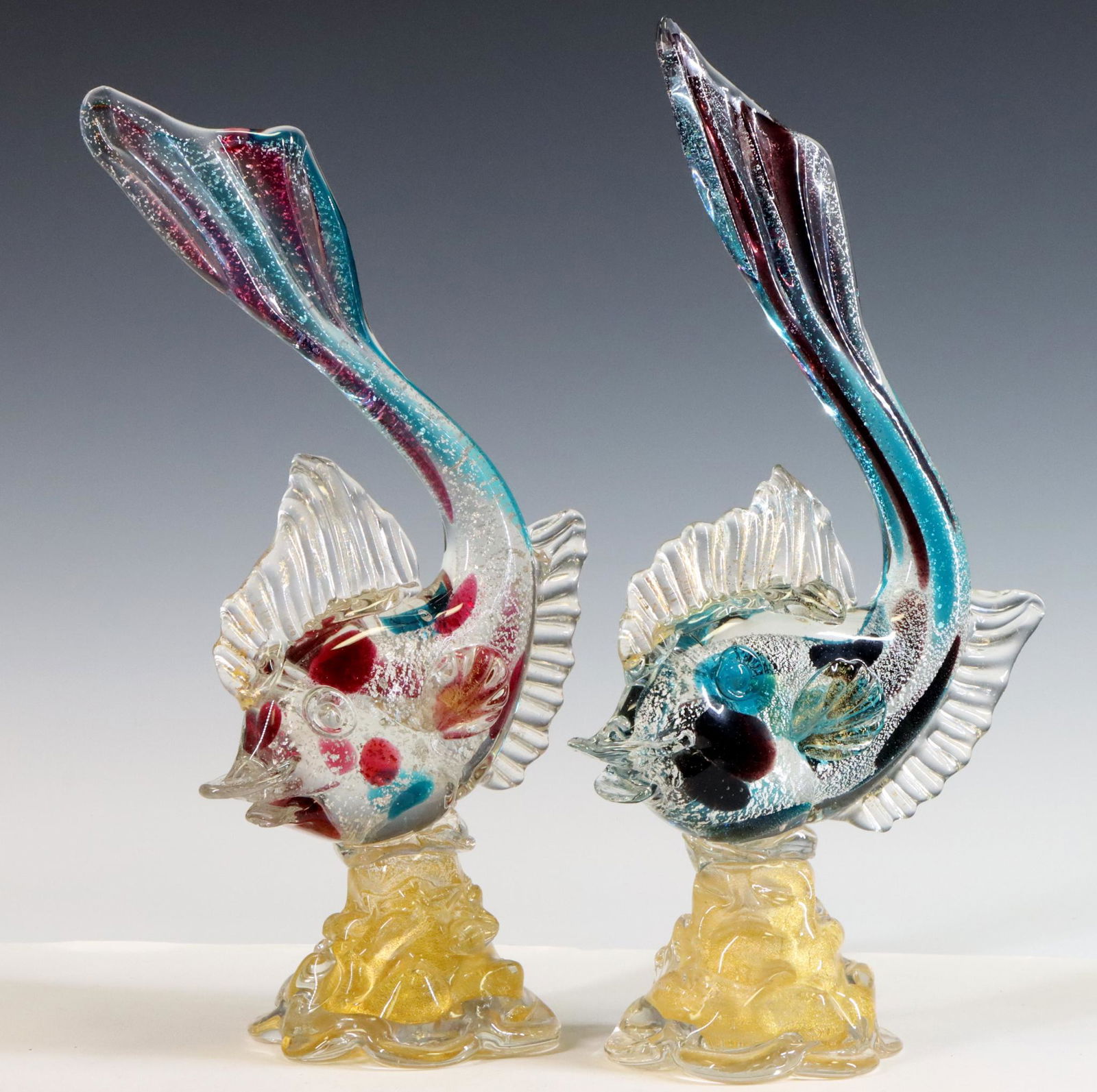 Murano Art Glass Fish: Italian blown glass pair of fish with red and blue patches, silver foil, and gold aventurine, labeled. 12.5"h x 6.5"w **Please Note: This item is NOT eligible for in-house shipping. Please refer to th