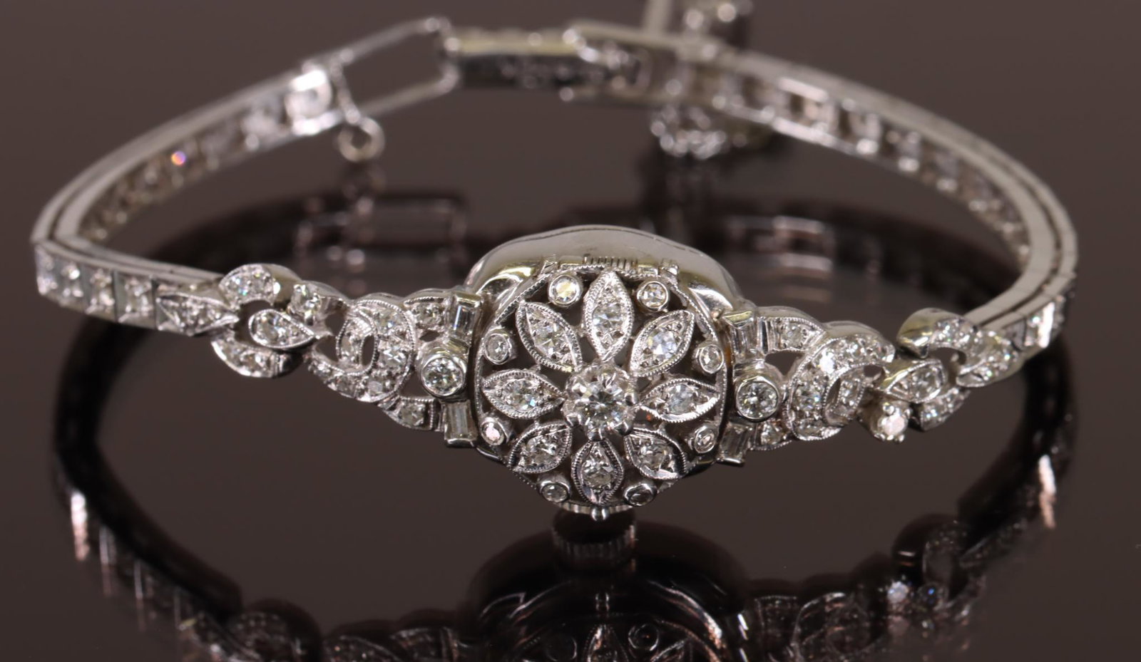14KW Gold Diamond Hamilton Ladies Wrist Watch: Hamilton ladies wrist watch in 14kw gold features a hinged cover cage with diamonds. Fancy lug ends feature round and baguette diamonds with round diamonds extending the length of the bracelet. Approx