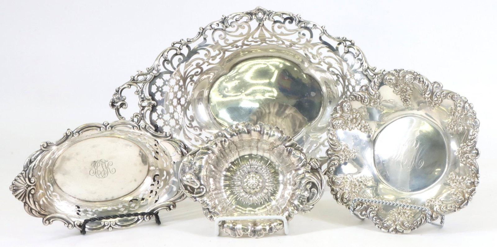 Sterling Silver Sweetmeats Dishes: Openwork oval baskets (2), the smaller by Gorham, the larger retailed by J.E. Caldwell. Repousse floral bowls (2), the larger by J.F. Fradley, the smaller by Reed and Barton with 1951 date mark. (2) p
