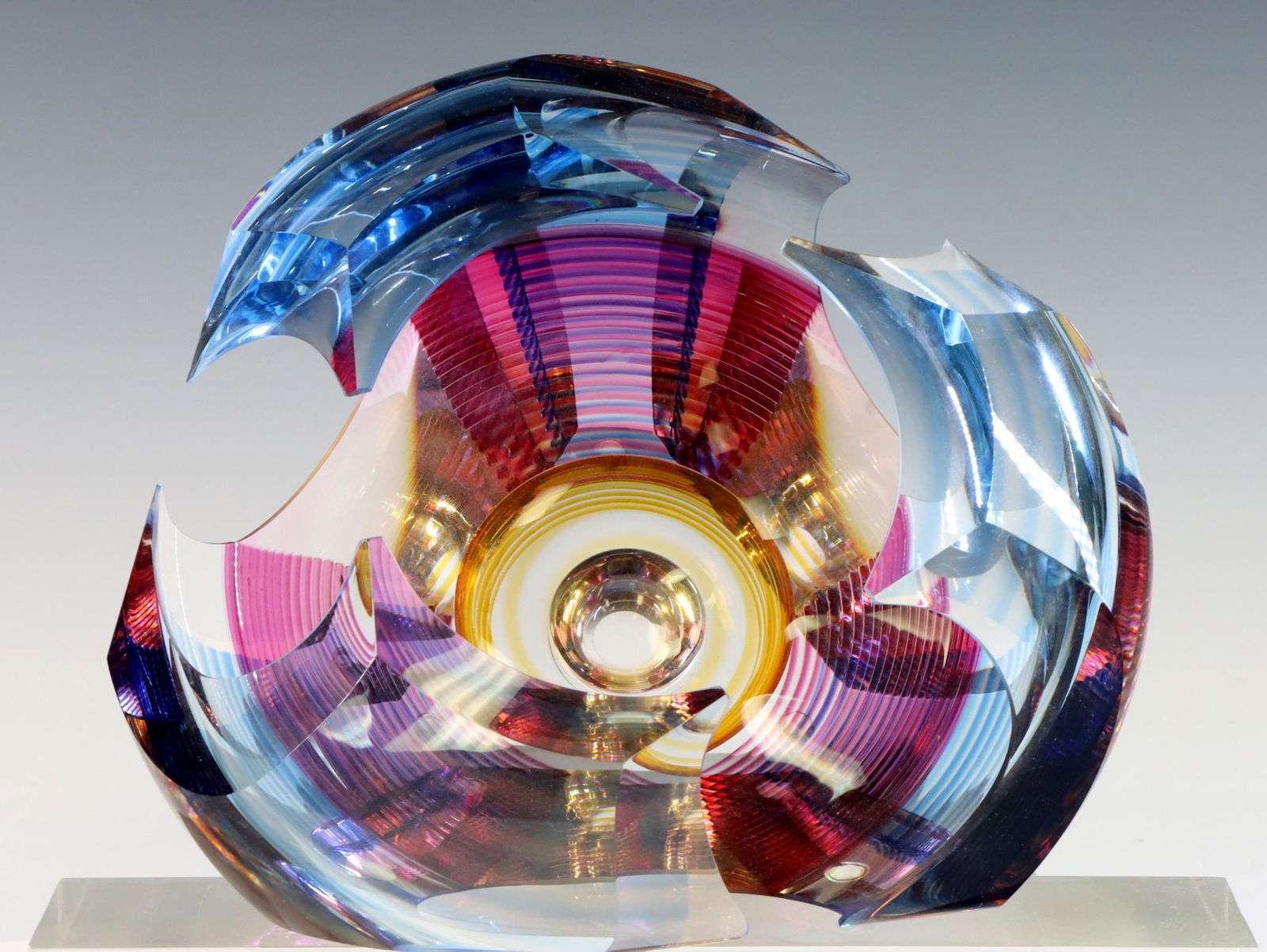 Michael David and Kit Karbler Art Glass Bowl: "Vortex Bowl", polychrome cut and faceted blown glass, designed to sit flat or on its side, signed to the foot. 4.5"h x 8"w when flat **Please Note: This item is NOT eligible for in-house shipping. Pl