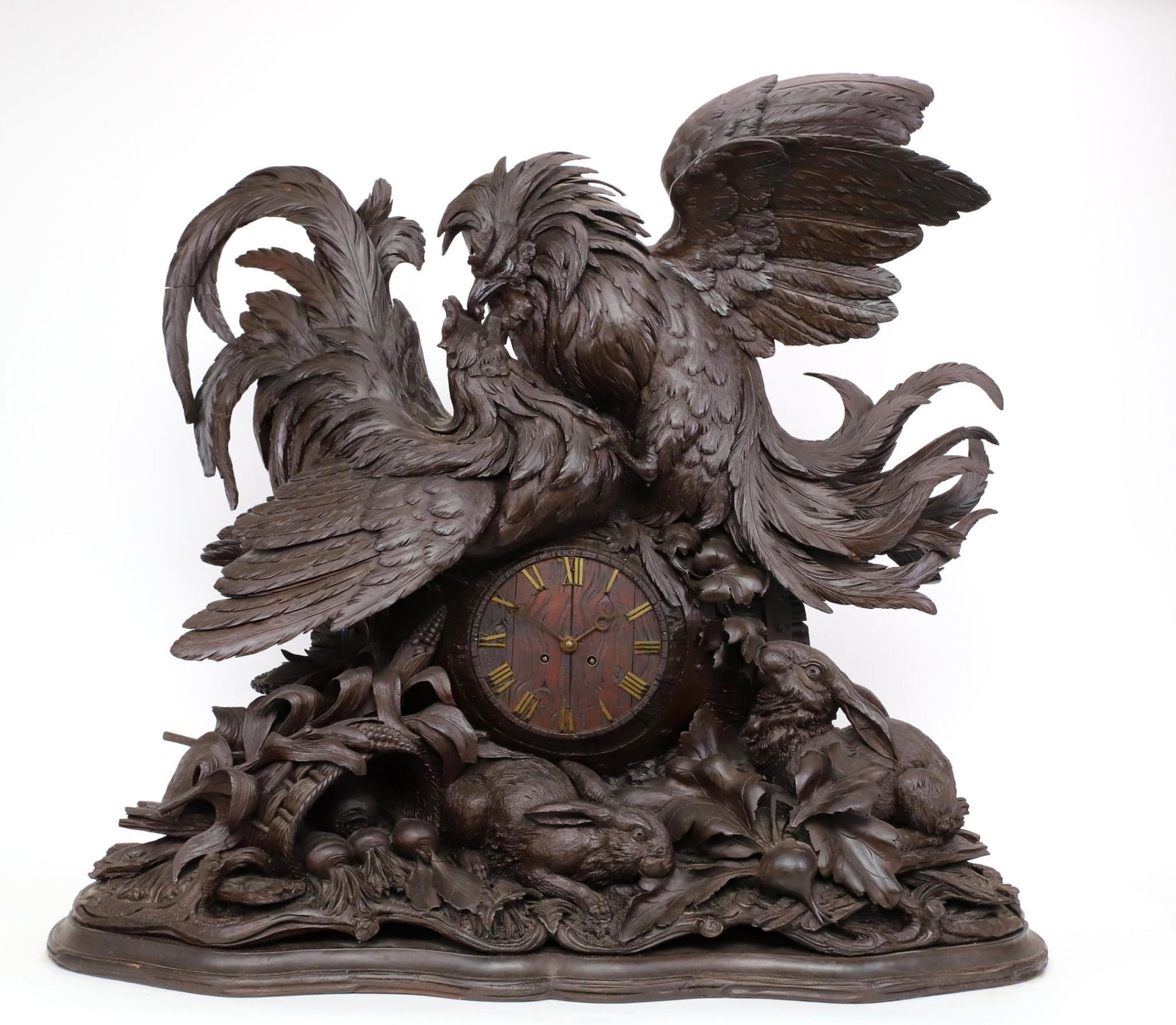Monumental 19th c. German Black Forest Carved Clock and Music Box: High relief mantel clock with roosters fighting on top of the barrel form clock face, with rabbits, vegetables, and foliage below. The clock face with applied brass Roman numerals, the French movement