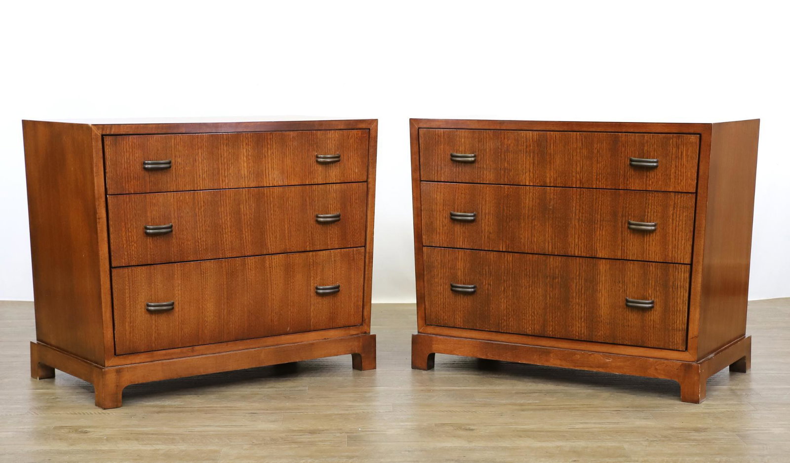 Mariette Himes Gomez for Hickory Chair, "Havana" Chests: Trapezoidal form pair of chests with three graduated drawers and straight feet, elm with a walnut finish, labeled. 28.25"h x 34.25"w (top) x 19"d **Please Note: This item is NOT eligible for in-house