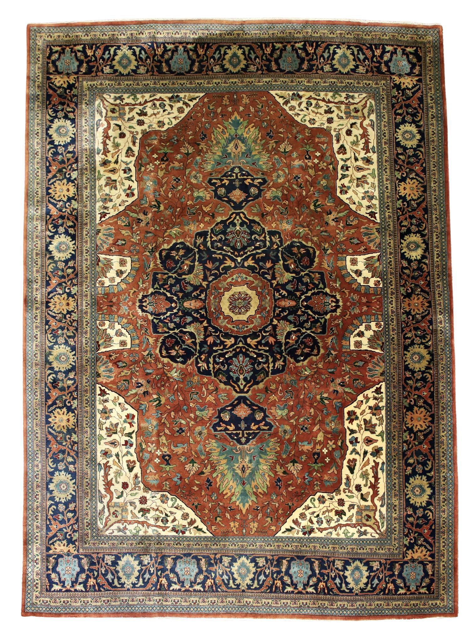 Ferahan Persian Room Size Rug: Hand-knotted having floral and vine motifs,a cloud collar medallion with pendants in a salmon field with ivory spandrels and a repeating pattern navy blue main border. Mid 20th c. Discoloration in one